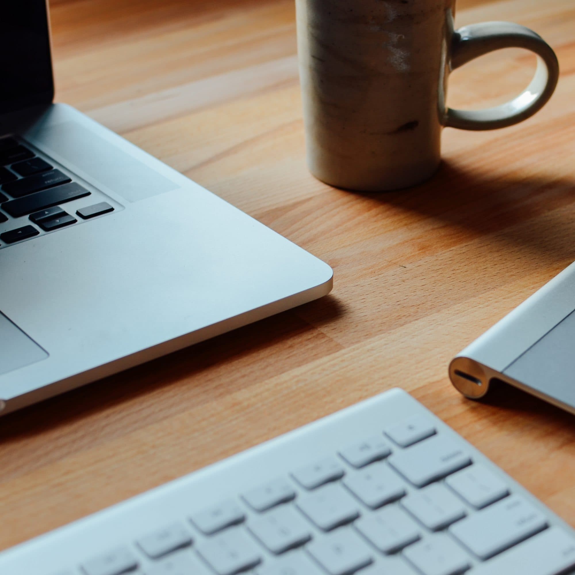 A laptop and a mug on a desk