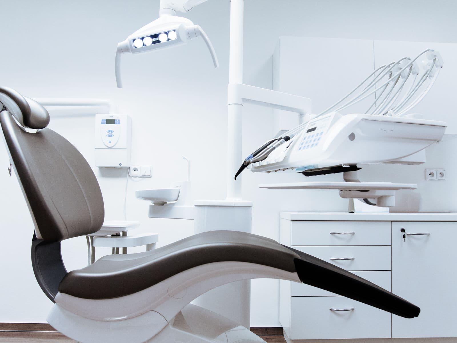 Empty dental chair in a bright treatment room