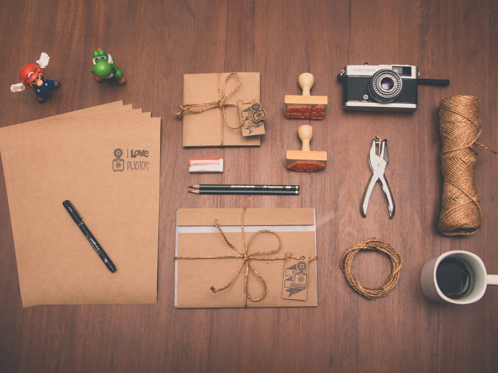 Wrapped parcels, twine and packing tools laid out on a wooden table
