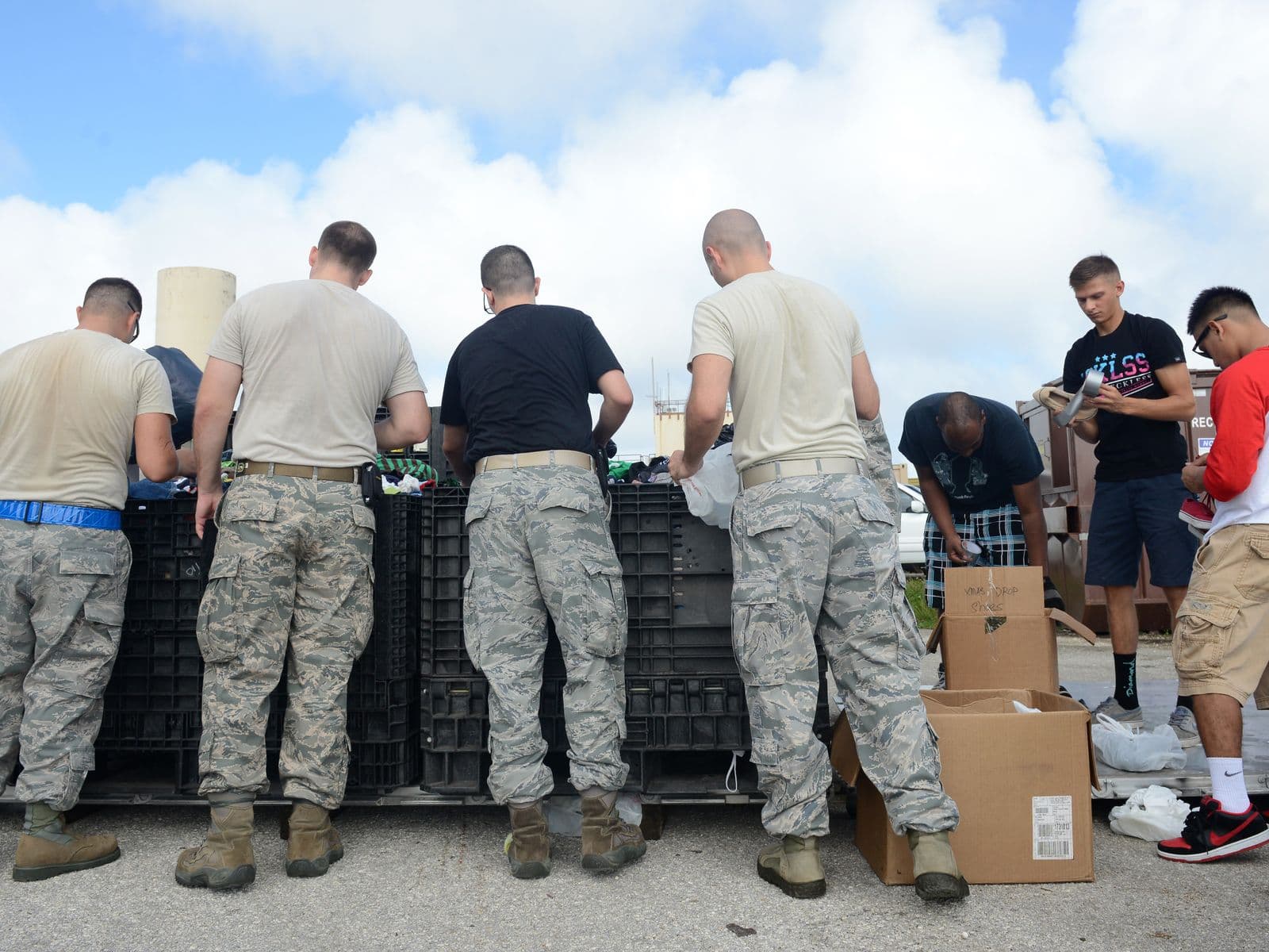 Volunteers sorting donated goods into bins