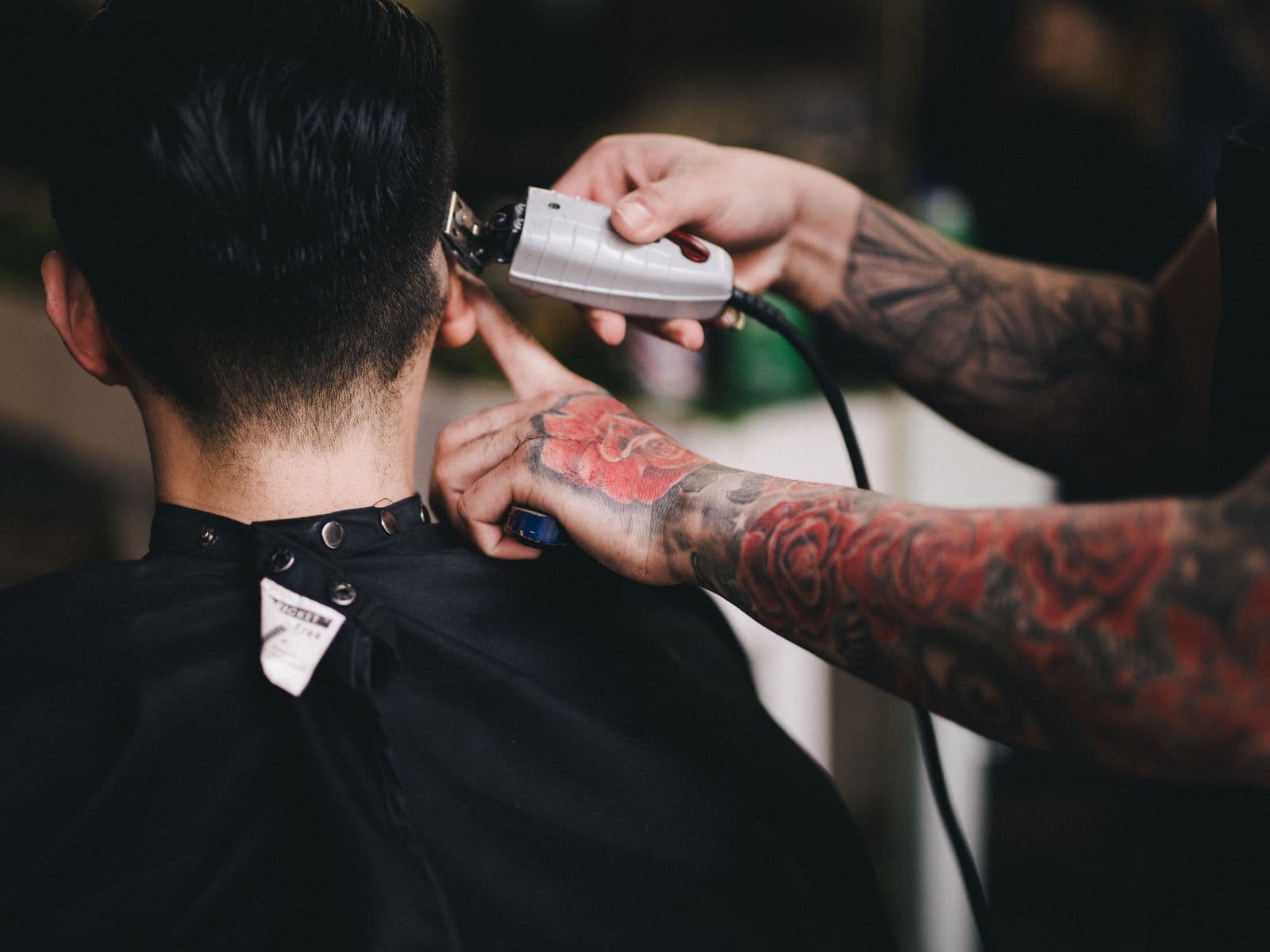 Barber trimming a client's hair with clippers